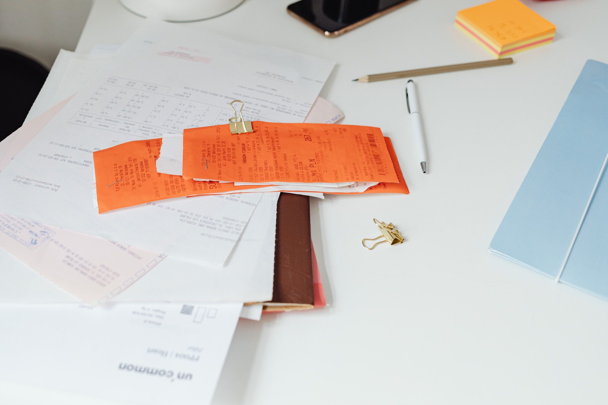 Close-up of a tidy desk with receipts, documents, and office stationery for business organization