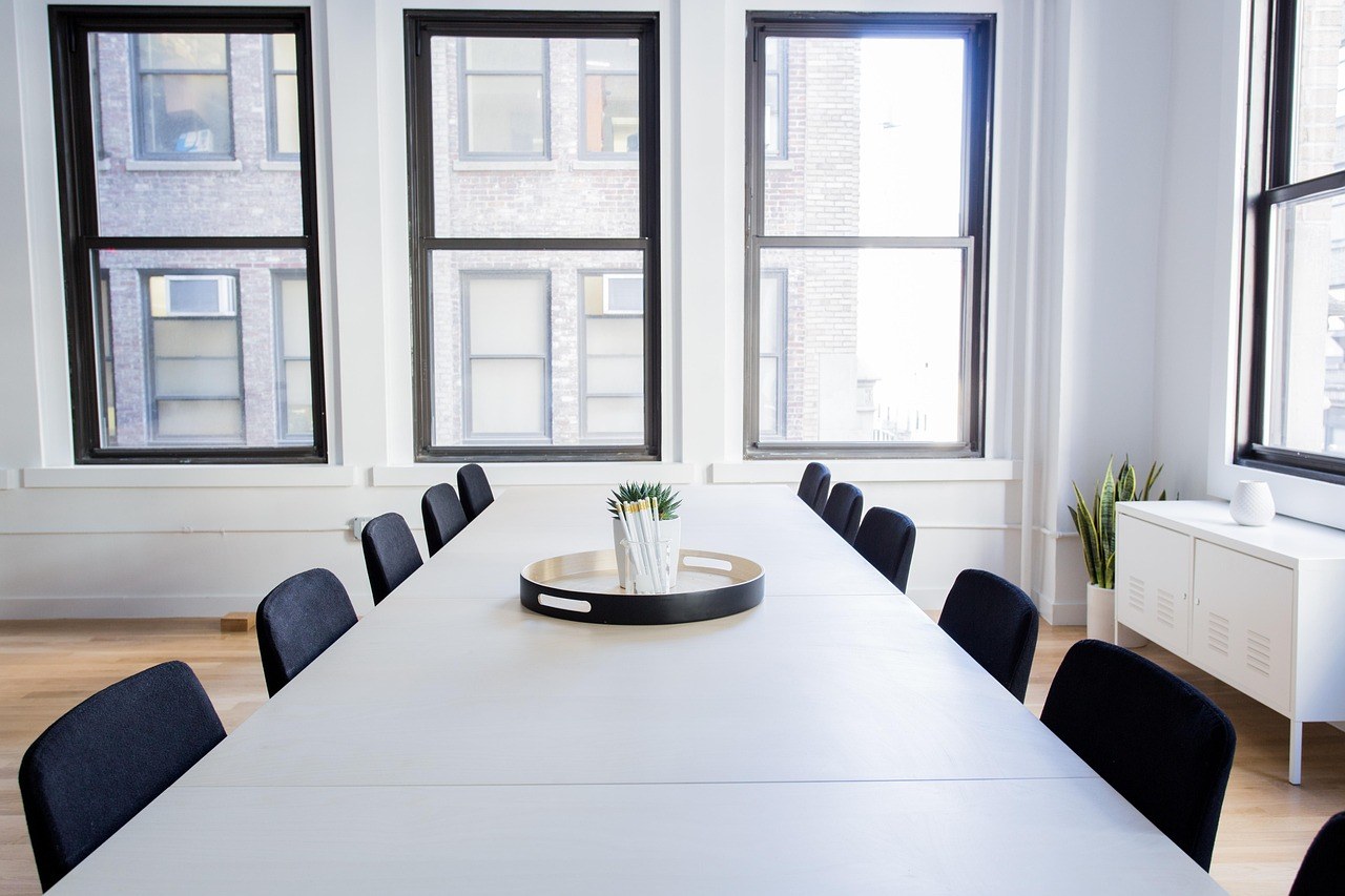 An empty conference room lit by a wall of windows, illustrating lawyer fees in Dubai