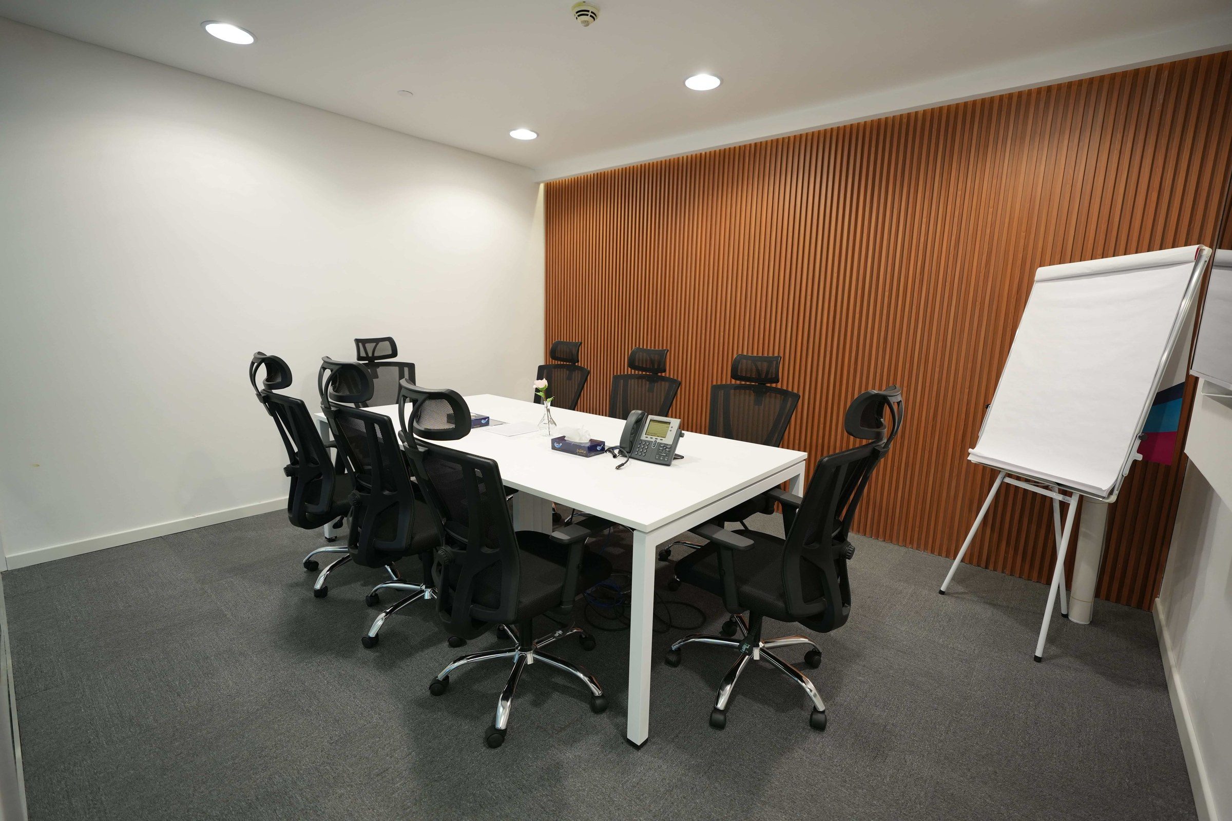 A meeting room with a long table and ergonomic chairs, illustrating a free consultation with a lawyer in Dubai