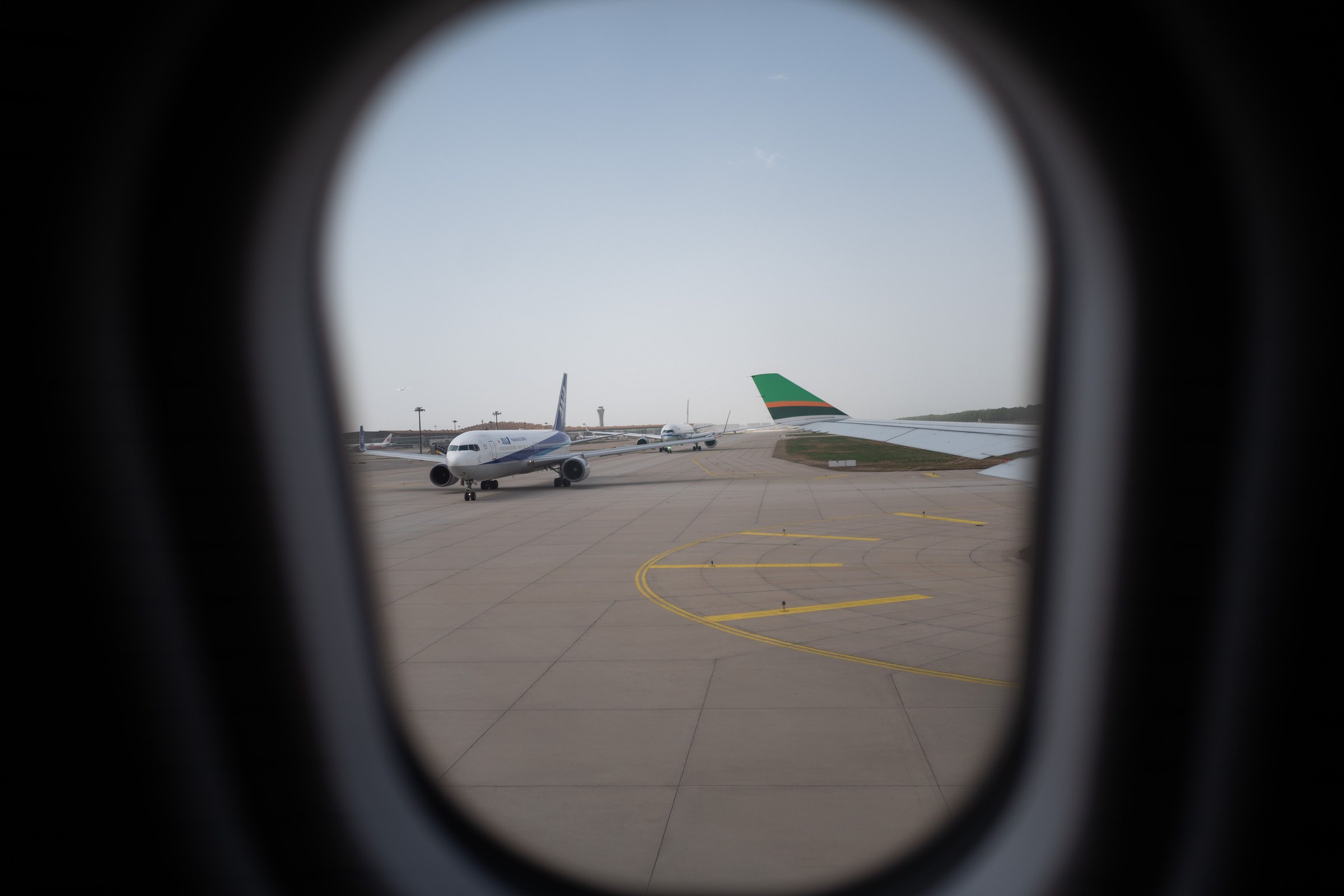 An aircraft seen through a terminal window on the stand, illustrating UAE golden visa eligibility