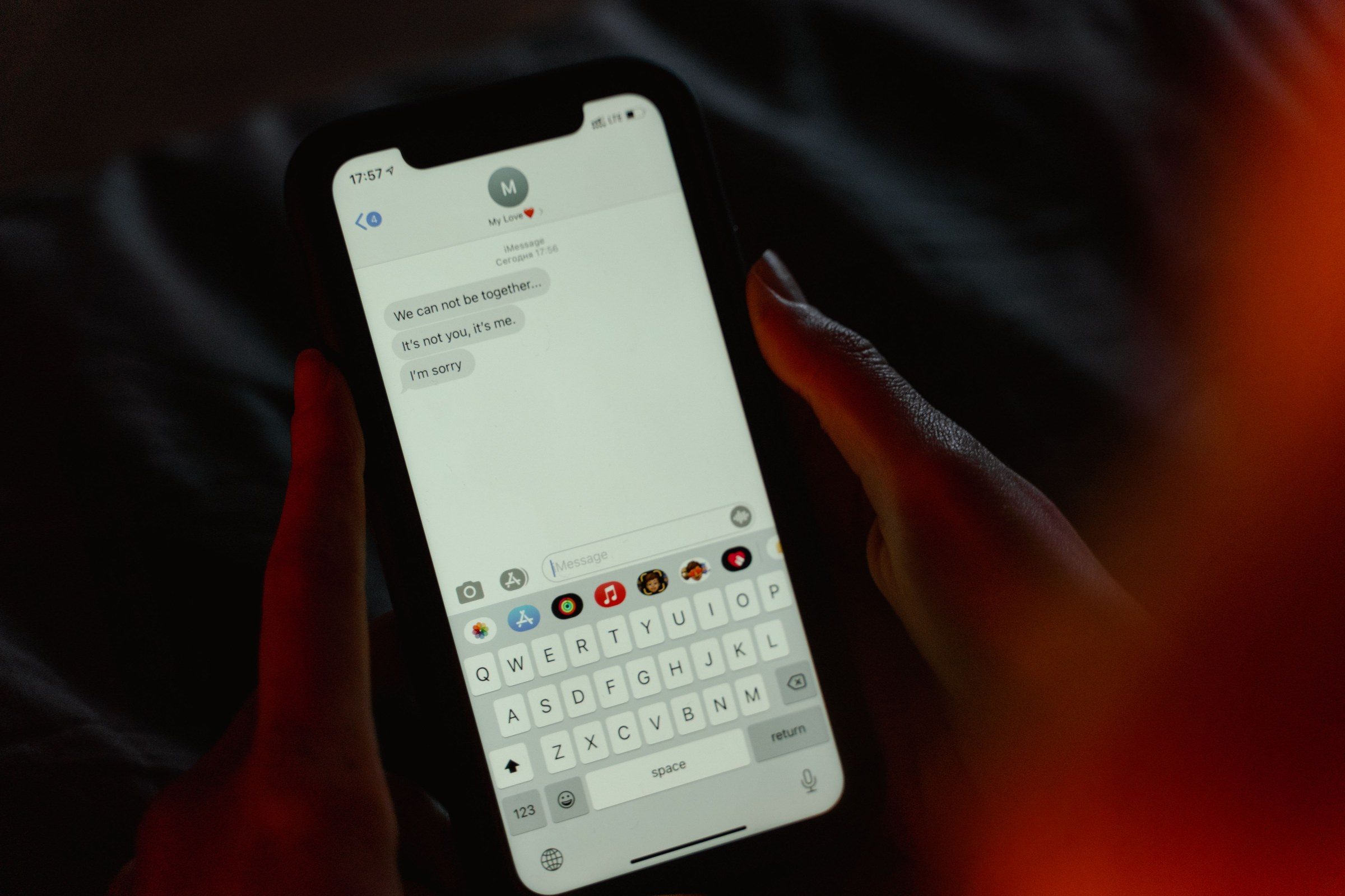 A message open on a smartphone screen held in both hands, illustrating the work of a cyber crime lawyer in Dubai