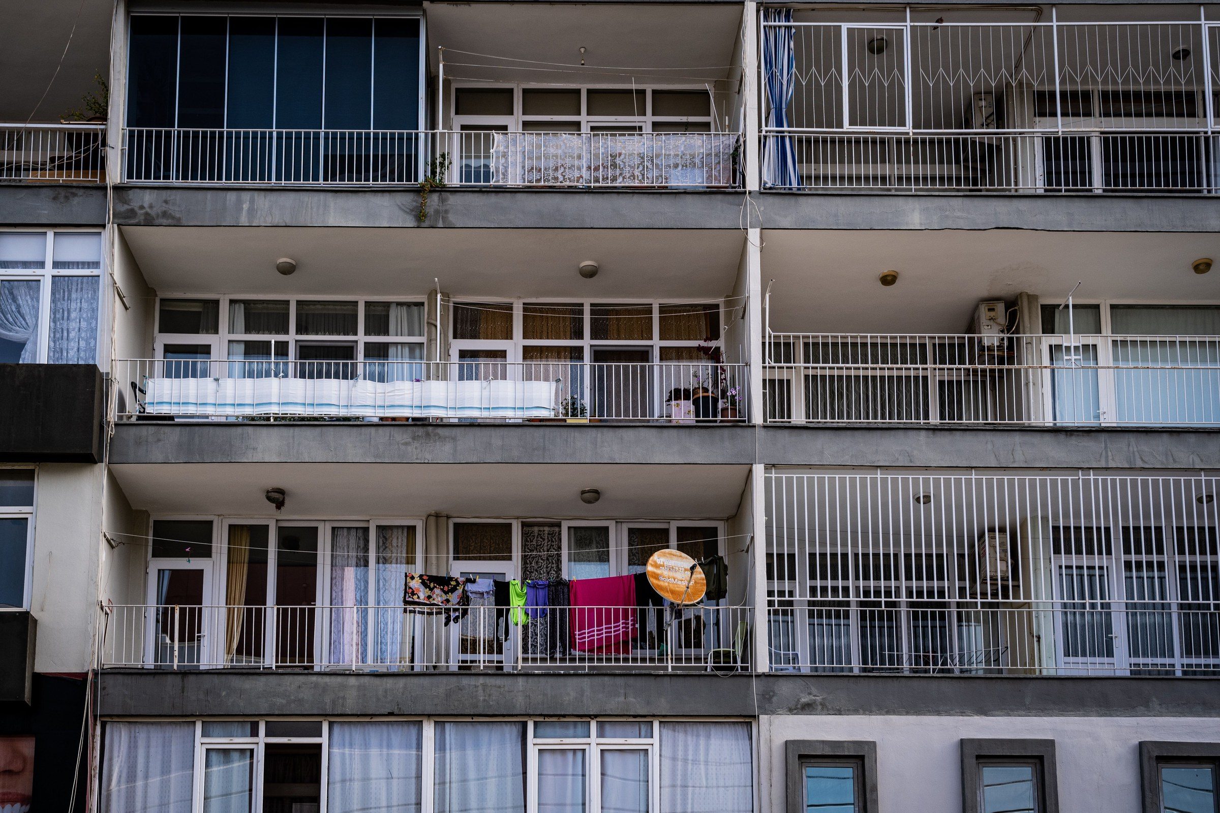 Low angle view of a modern apartment building showcasing balconies and glass windows
